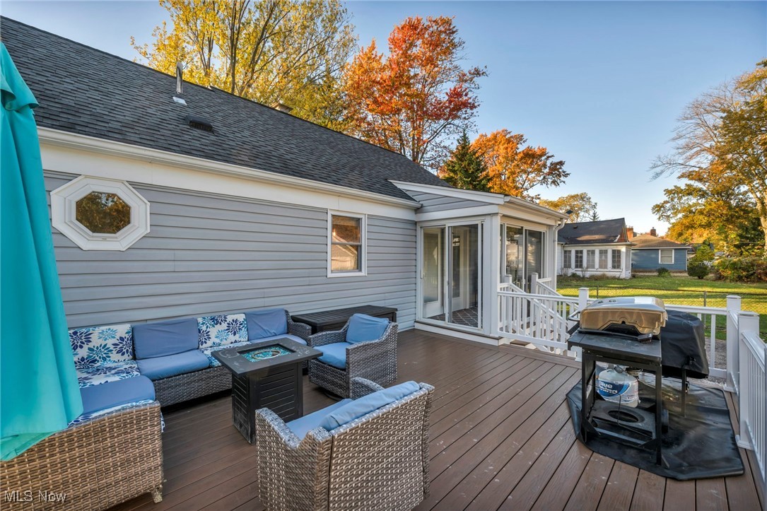149 Jaycox Road Avon Lake, OH 44012 - Photo 9 of 42 Wooden deck with grilling area, an outdoor living space with a fire pit, and a sunroom