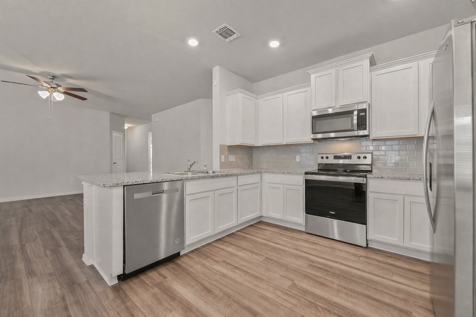 108 Pivot Drive Taylor, TX 76574 - Photo 12 of 30 a kitchen with stainless steel appliances granite countertop a stove a sink and a refrigerator