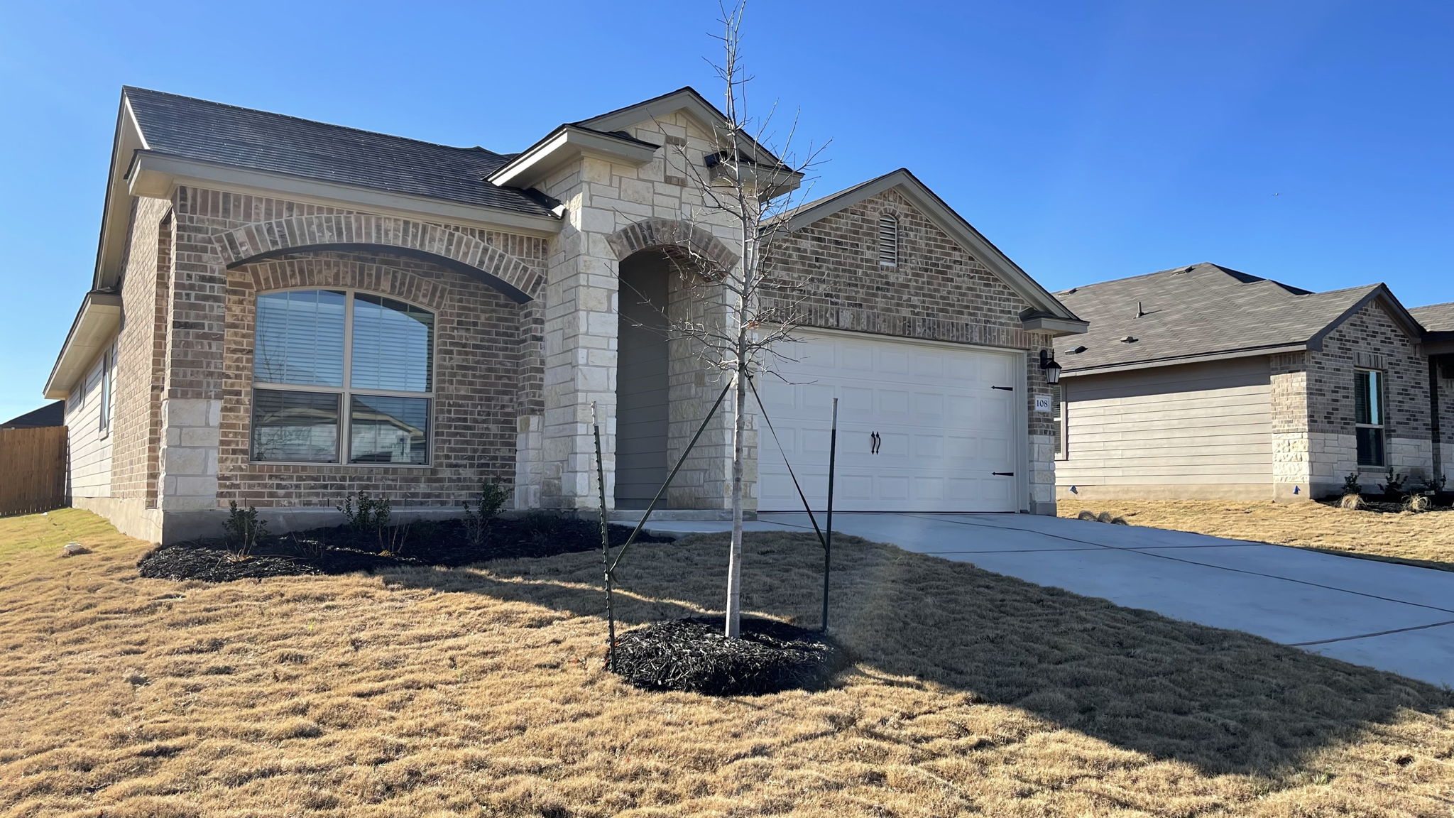 108 Pivot Drive Taylor, TX 76574 - Photo 2 of 30 a front view of a house with garden