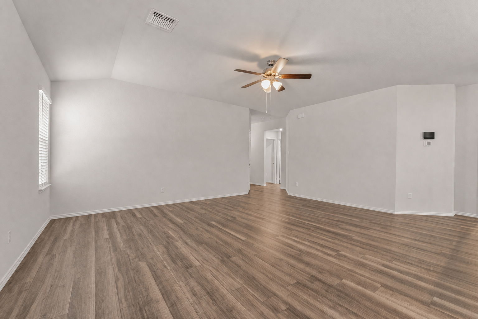 108 Pivot Drive Taylor, TX 76574 - Photo 4 of 30 a view of empty room with wooden floor and fan