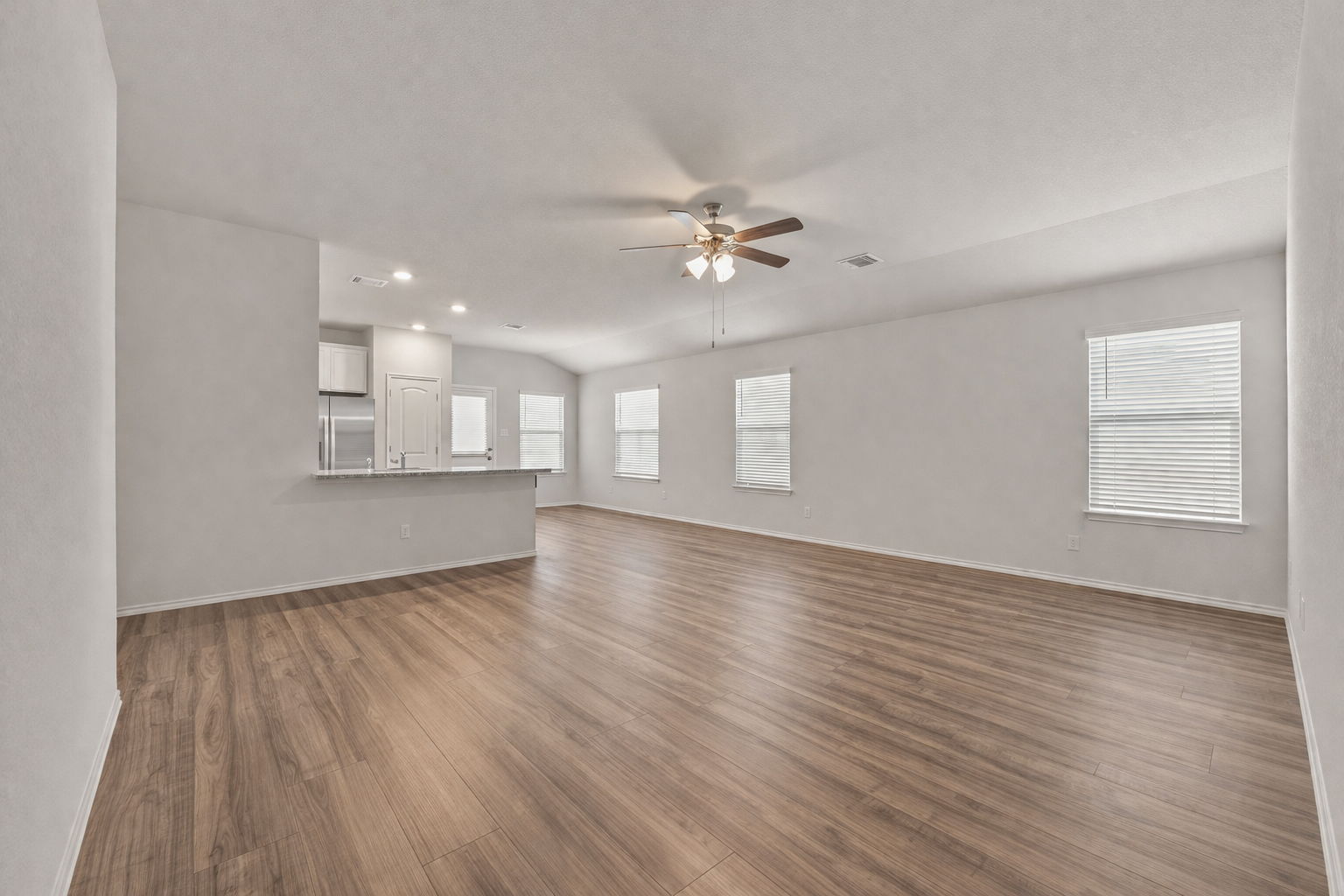108 Pivot Drive Taylor, TX 76574 - Photo 5 of 30 a view of an empty room with a window and wooden floor