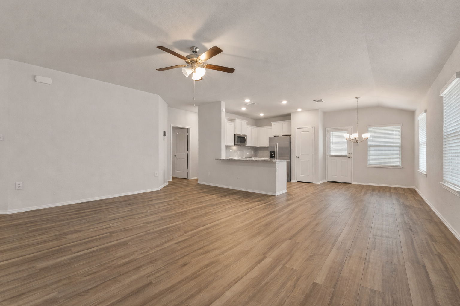 108 Pivot Drive Taylor, TX 76574 - Photo 6 of 30 a view of empty room with wooden floor and kitchen