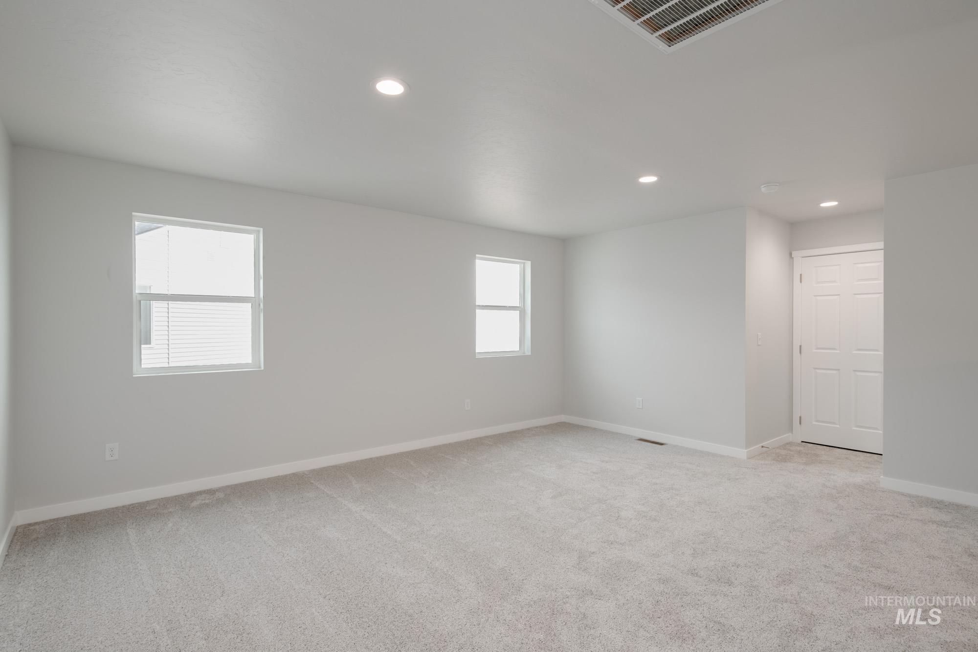 2502 West Fallon Loop Nampa, ID 83651 - Photo 15 of 21 Unfurnished room featuring recessed lighting, light carpet, and cooling unit