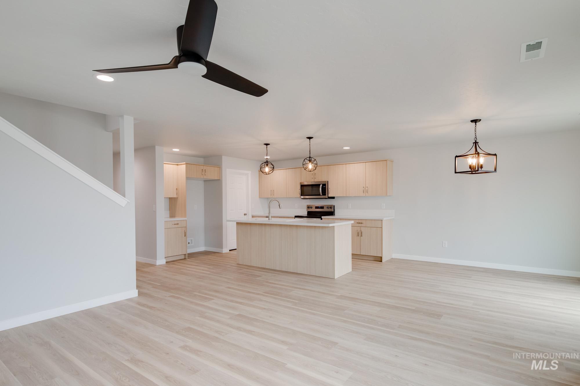 2502 West Fallon Loop Nampa, ID 83651 - Photo 21 of 21 Kitchen featuring open floor plan, recessed lighting, light countertops, pendant lighting, and a ceiling fan