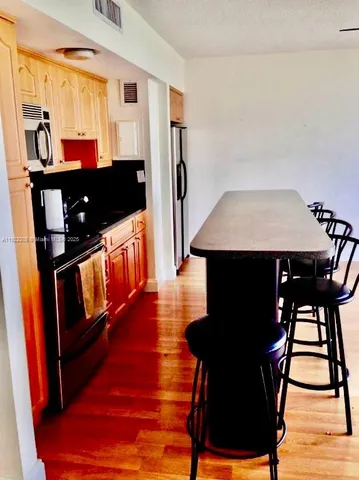 a view of a room with furniture and wooden floor