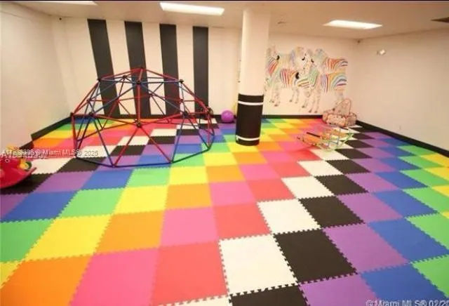 a view of an empty room with a rug