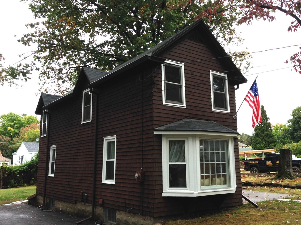 89 Judson Street Springfield, MA 01104 - Photo 1 of 12 a front view of a house with a tree