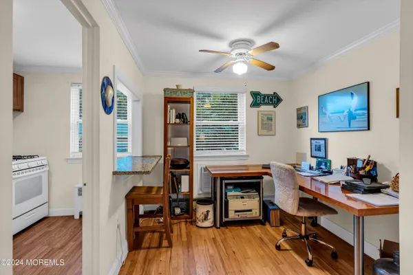 a view of a workspace with furniture and a window