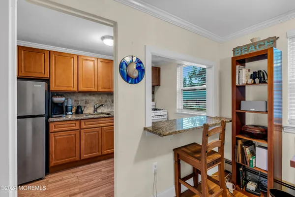 a kitchen with granite countertop a stove and a refrigerator