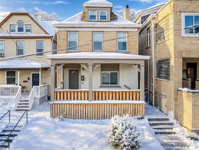 a view of a brick house with large windows