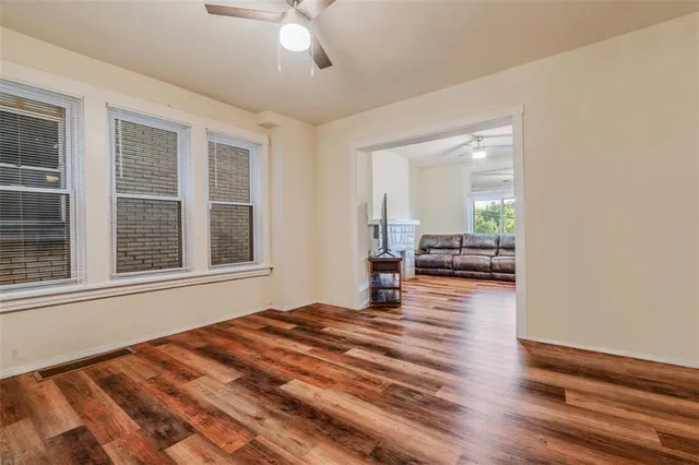 a view of a bedroom with wooden floor