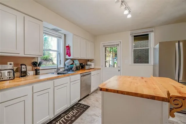a kitchen with stainless steel appliances granite countertop a sink and a stove