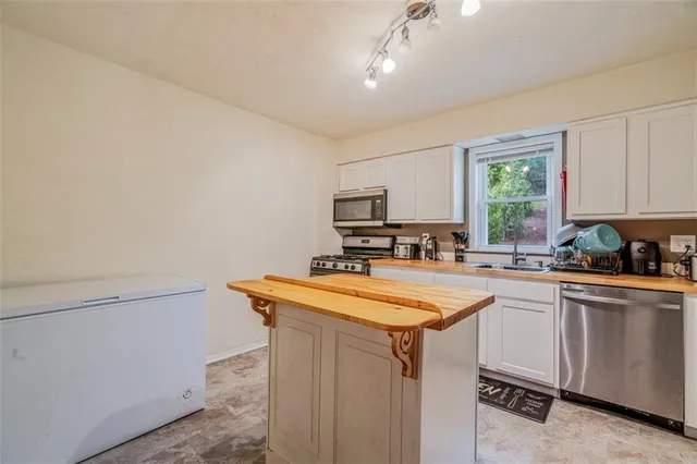 a bedroom with a bed a dresser and book shelf