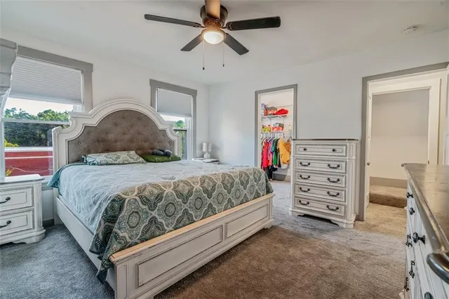 a bedroom with a large bed and a chandelier
