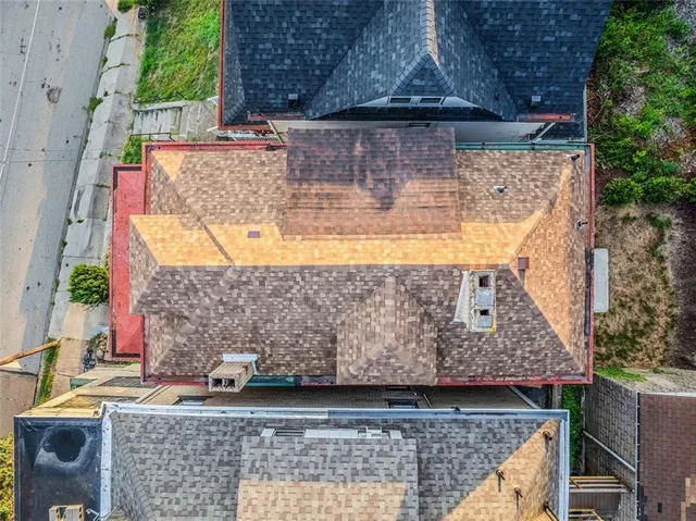 an aerial view of a house with a yard