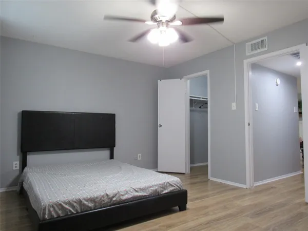 a bedroom with a bed and a ceiling fan