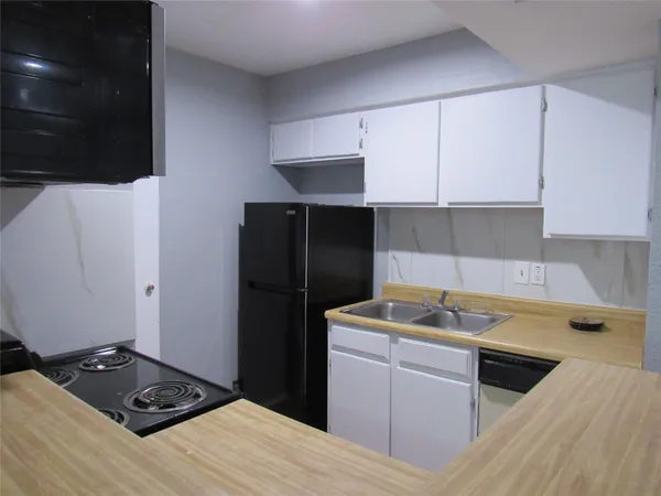 a kitchen with stainless steel appliances granite countertop a sink and a stove top oven
