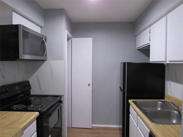 a view of hallway with wooden floor