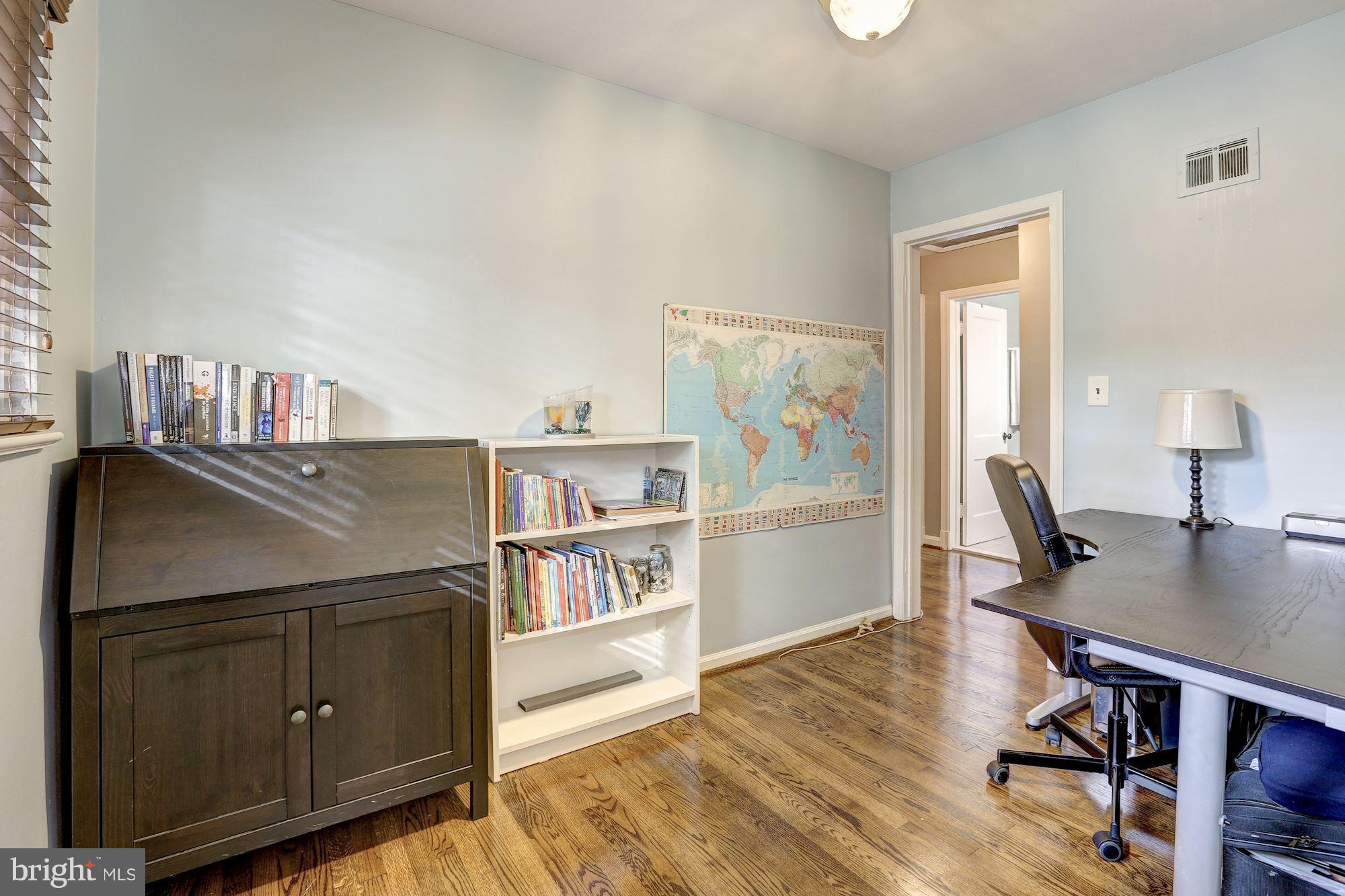10205 Procter Street Silver Spring, MD 20901 - Photo 24 of 38 a view of a workspace with furniture and wooden floor