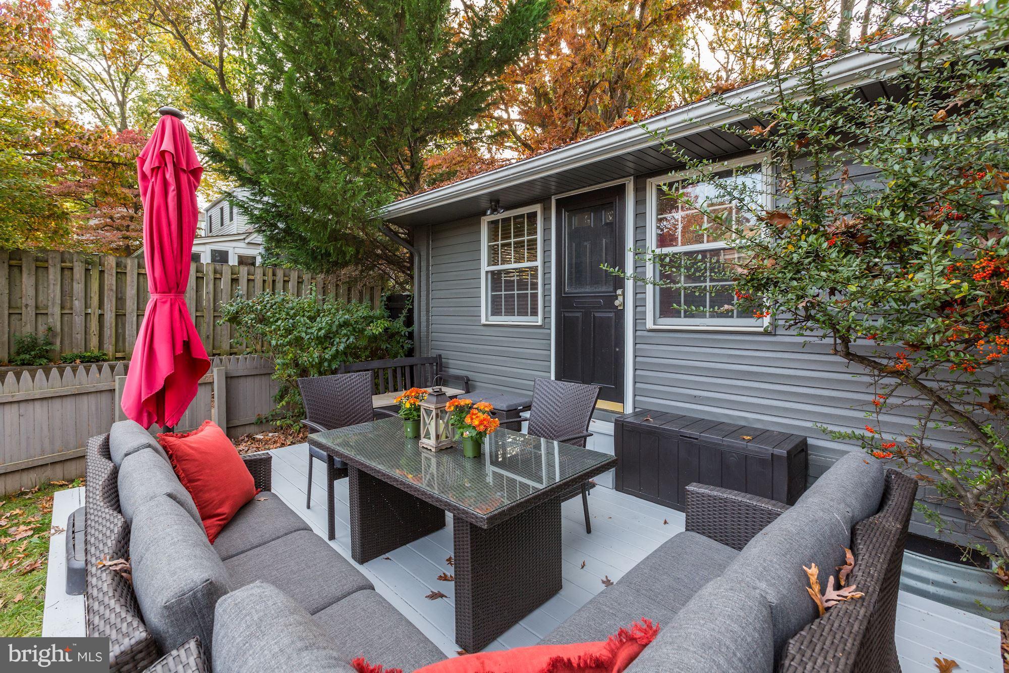 10205 Procter Street Silver Spring, MD 20901 - Photo 29 of 38 a view of a patio with couches table and chairs and potted plants