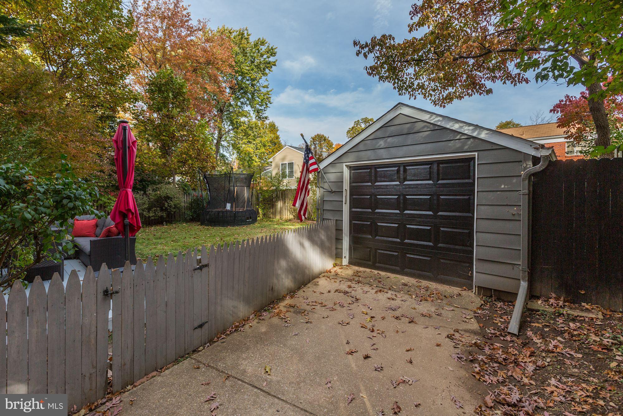 10205 Procter Street Silver Spring, MD 20901 - Photo 33 of 38 a view of a house with a wooden fence next to a yard