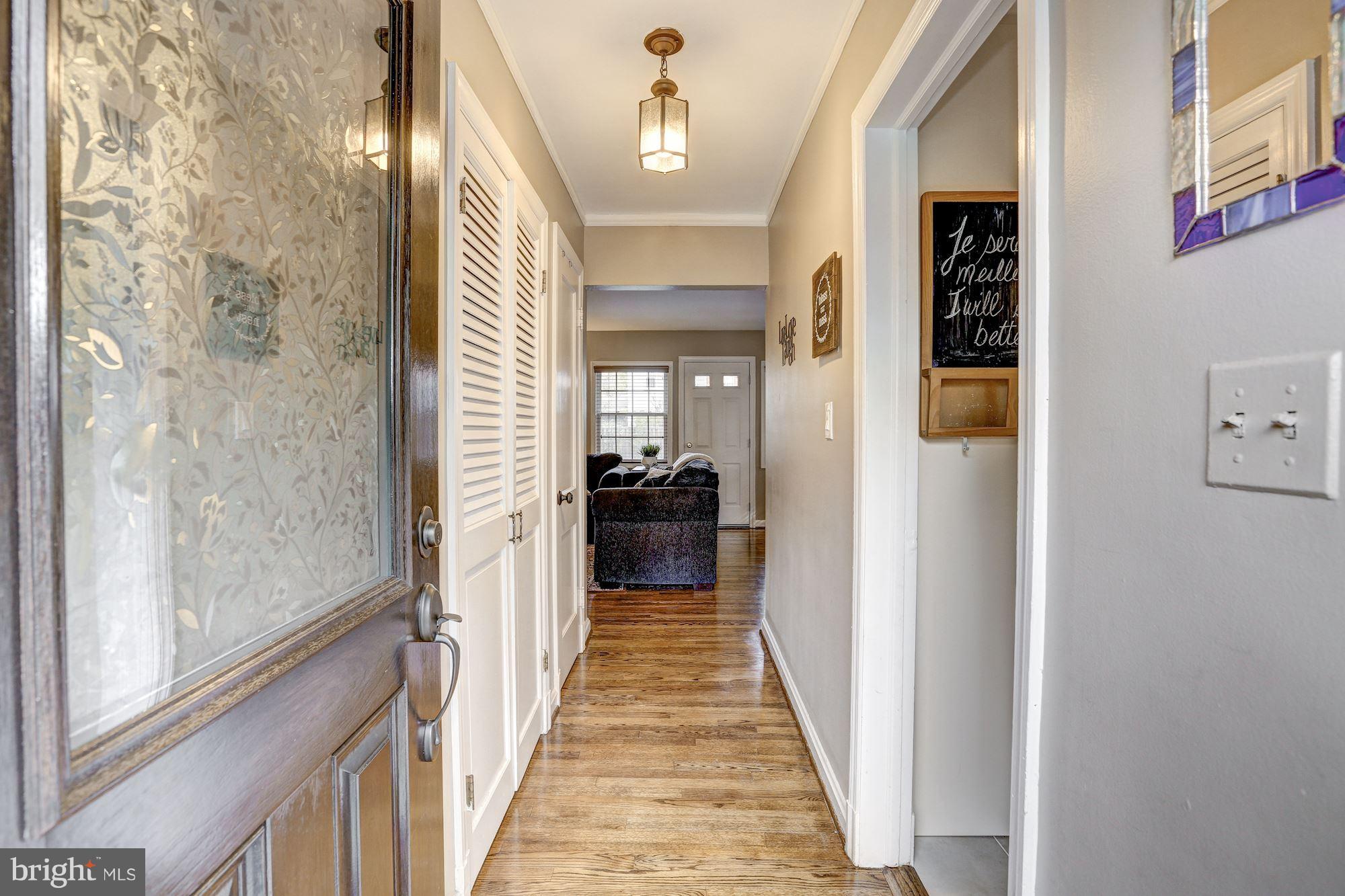 10205 Procter Street Silver Spring, MD 20901 - Photo 7 of 38 a view of a hallway with a livingroom and a chandelier