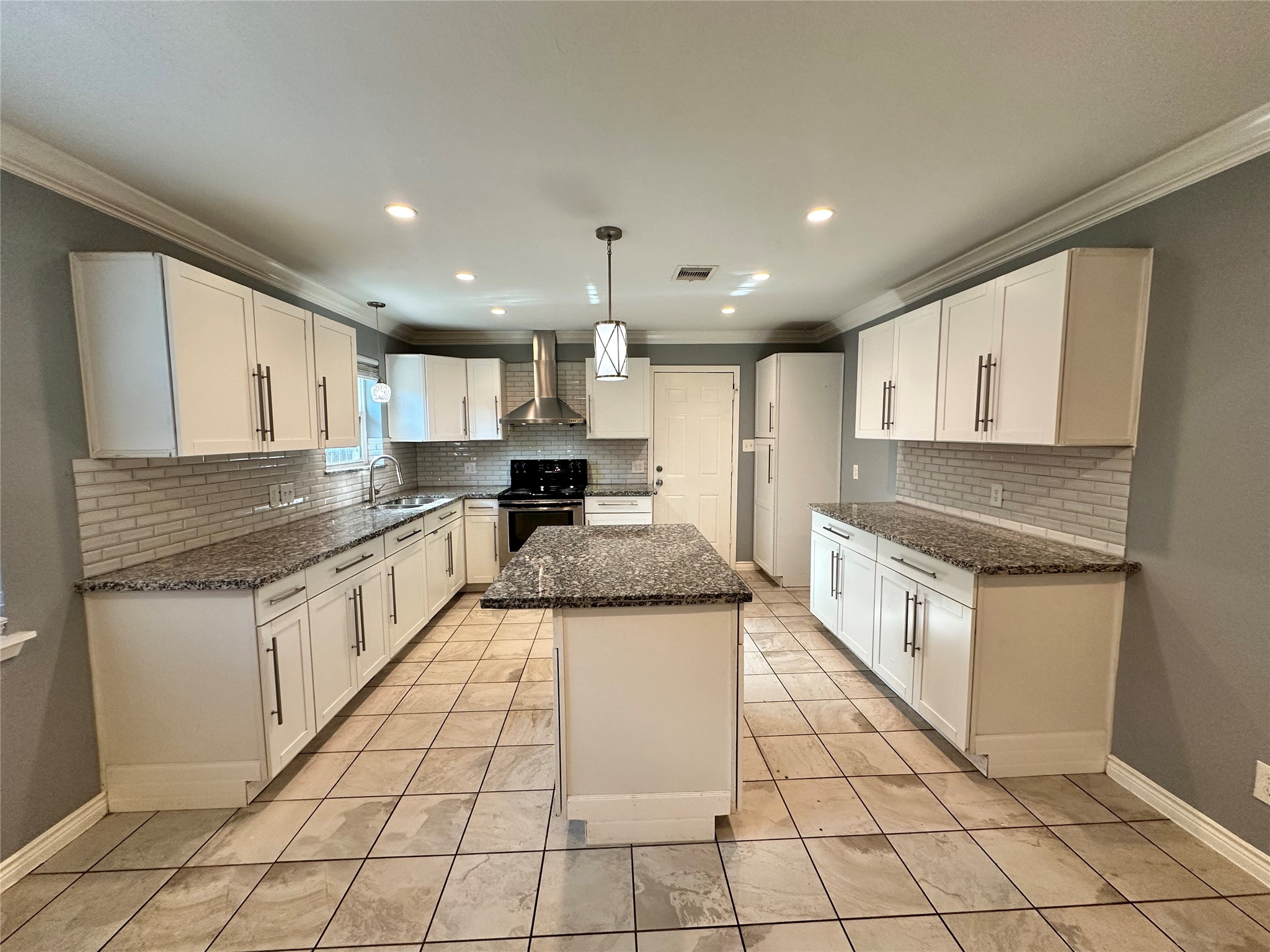 2206 South Houston Road Pasadena, TX 77502 - Photo 4 of 11 a kitchen with stainless steel appliances granite countertop a stove a sink and a microwave
