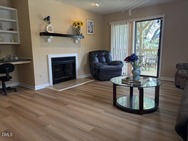 5816 Pointer Drive, Unit 102 Raleigh, NC 27609 - Photo 5 of 25 a living room with furniture and a fireplace