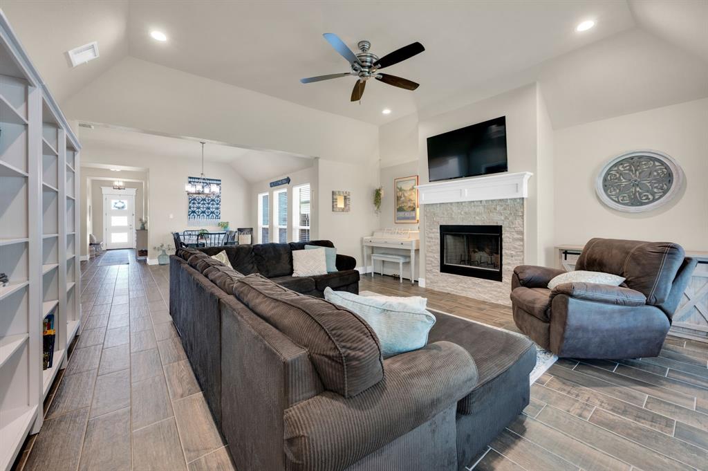 1313 Ridgeview Drive Weatherford, TX 76086 - Photo 15 of 34 Living area with vaulted ceiling, ceiling fan, wood finish floors, a fireplace, and recessed lighting