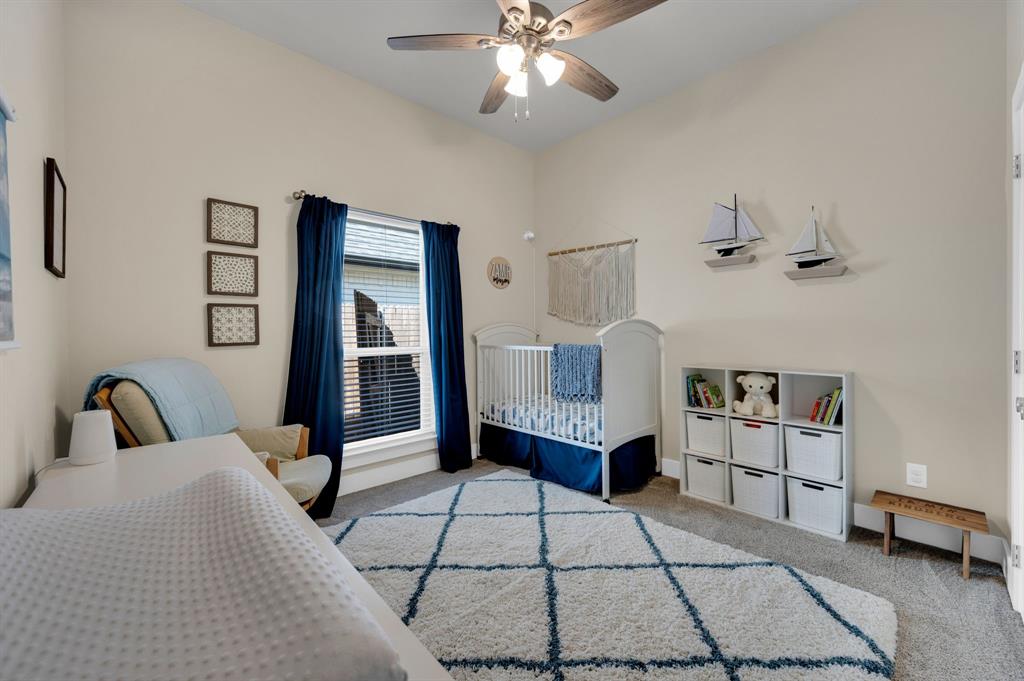 1313 Ridgeview Drive Weatherford, TX 76086 - Photo 17 of 34 Bedroom with a crib, ceiling fan, and light carpet