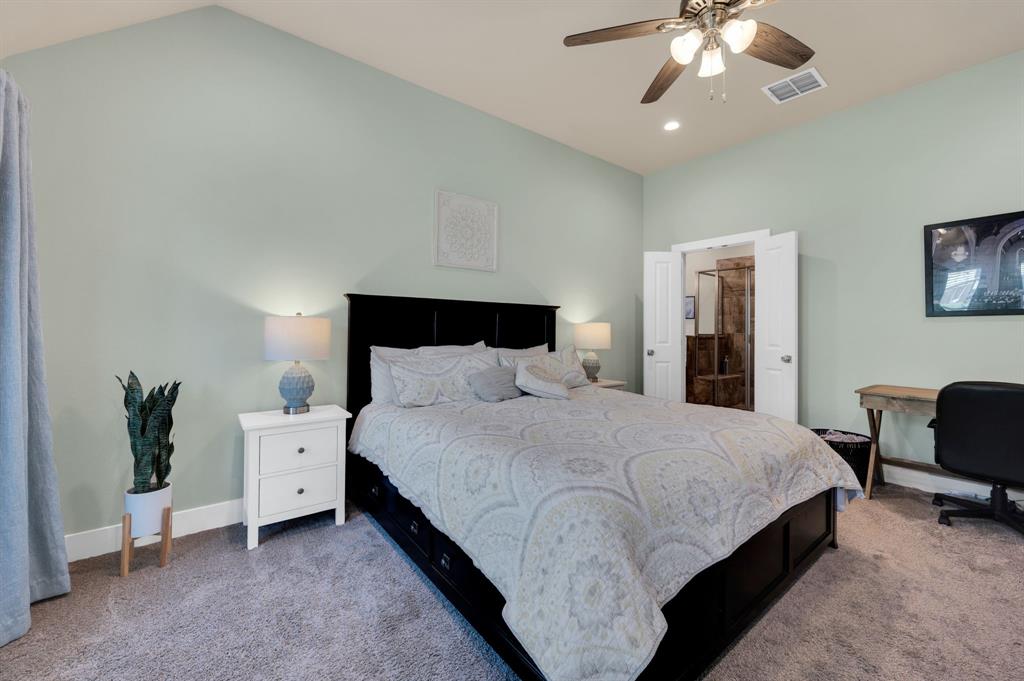 1313 Ridgeview Drive Weatherford, TX 76086 - Photo 20 of 34 Carpeted bedroom with vaulted ceiling and a ceiling fan