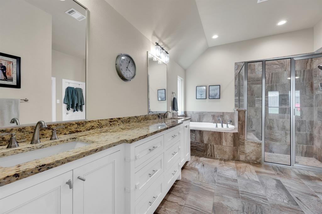 1313 Ridgeview Drive Weatherford, TX 76086 - Photo 25 of 34 Bathroom featuring double vanity, a shower stall, lofted ceiling, and a garden tub