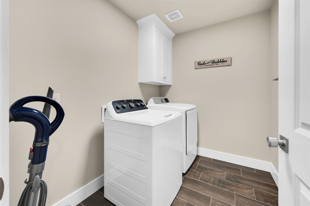 1313 Ridgeview Drive Weatherford, TX 76086 - Photo 27 of 34 Laundry area with wood finish floors, separate washer and dryer, and cabinet space