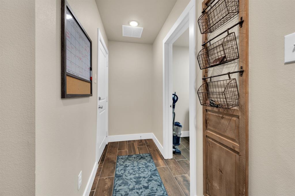 1313 Ridgeview Drive Weatherford, TX 76086 - Photo 28 of 34 Doorway to outside featuring wood tiled floors and a textured wall