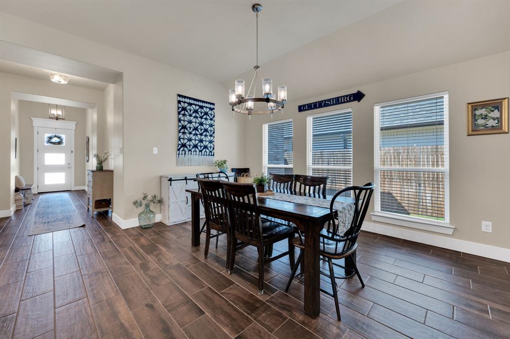 1313 Ridgeview Drive Weatherford, TX 76086 - Photo 8 of 34 Dining room with wood finish floors, a chandelier, and vaulted ceiling