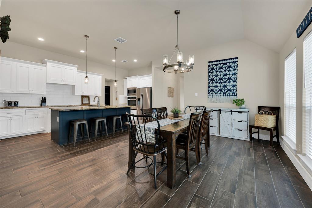 1313 Ridgeview Drive Weatherford, TX 76086 - Photo 9 of 34 Dining space with wood tiled floors, hanging lights, and vaulted ceiling