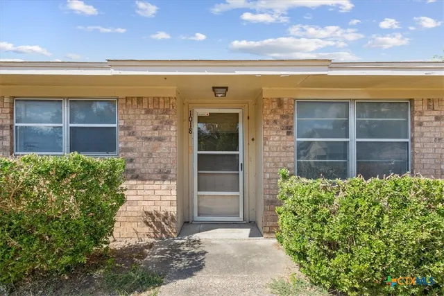 a view of front door and a window