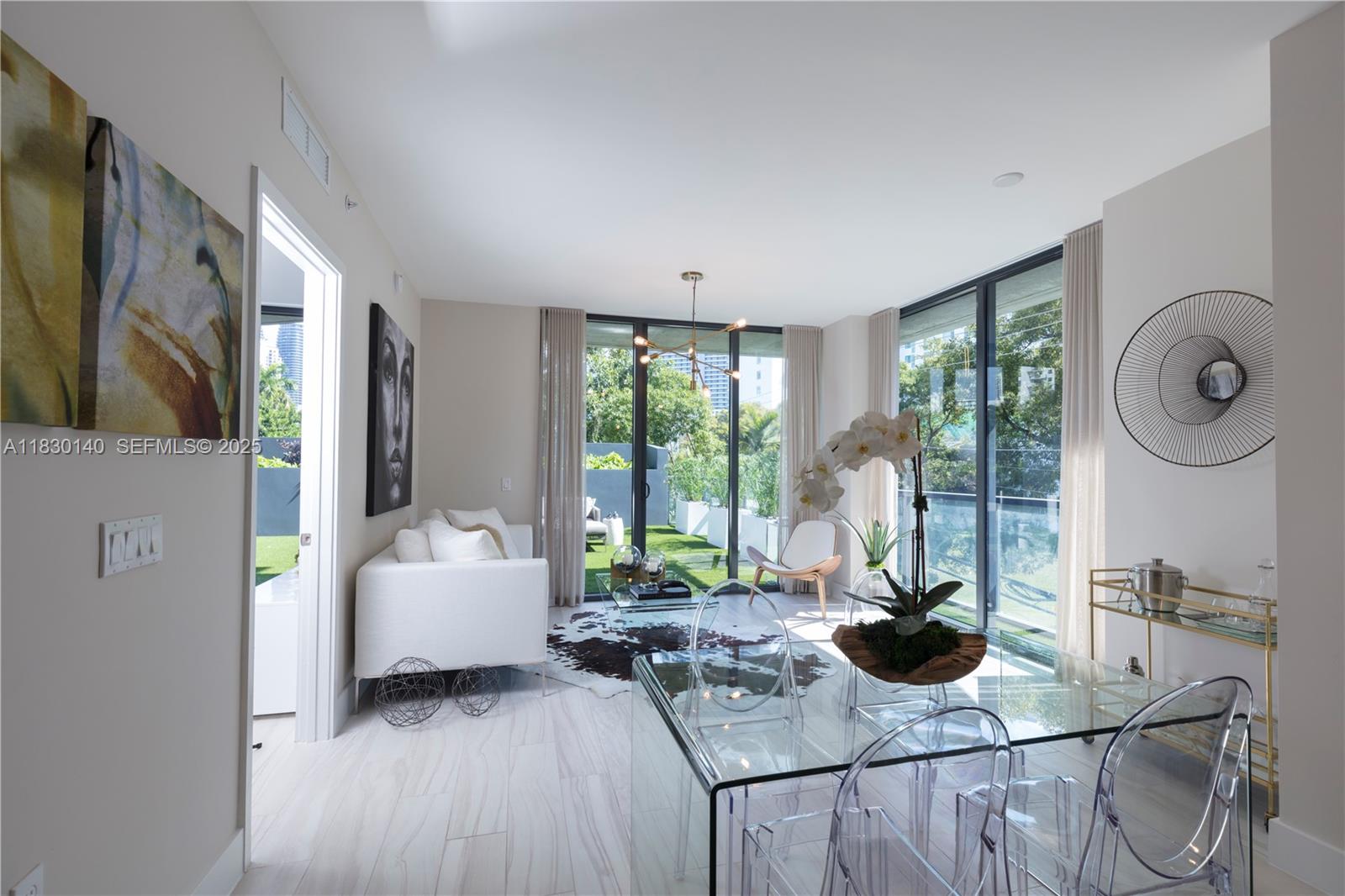 201 Southwest 17th Road, Unit 307 Miami, FL 33129 - Photo 15 of 26 a living room with furniture a large window and wooden floor