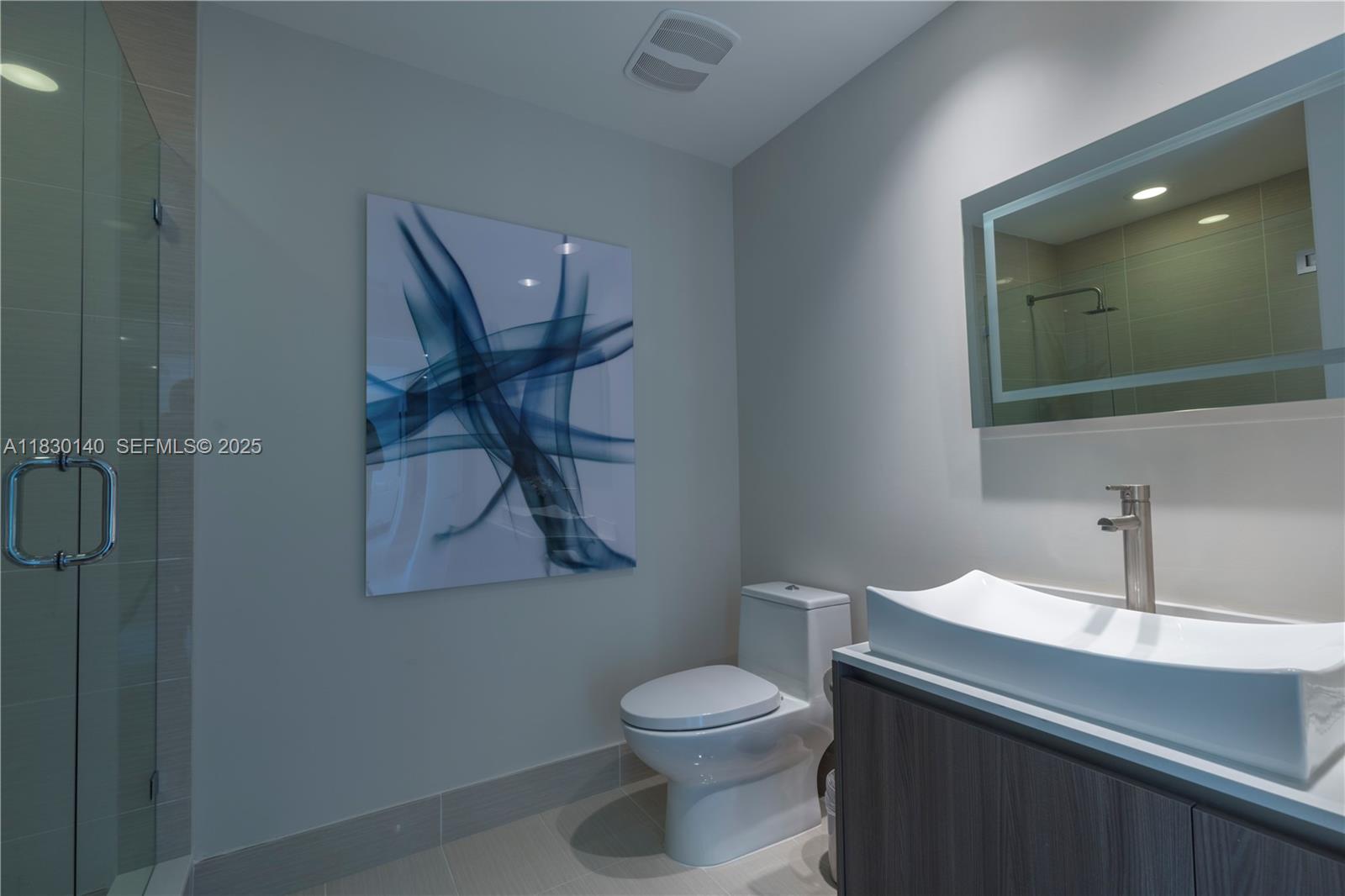 201 Southwest 17th Road, Unit 307 Miami, FL 33129 - Photo 18 of 26 a bathroom with a toilet sink and mirror