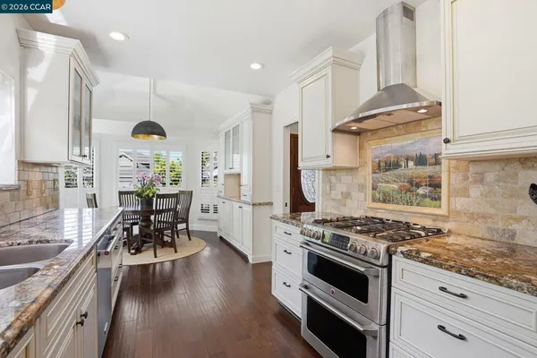 a kitchen with stainless steel appliances granite countertop a stove and a refrigerator