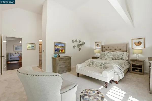a spacious bedroom with a bed and dresser