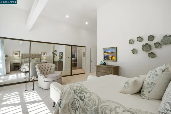 a bedroom with furniture and a large window