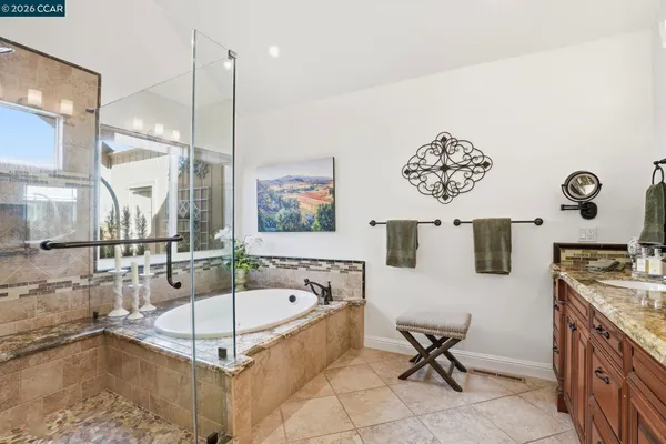a spacious bathroom with a tub a sink and a mirror