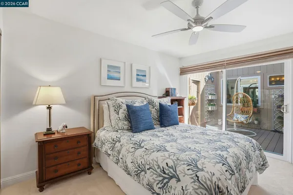 a large bedroom with a bed and a lamp