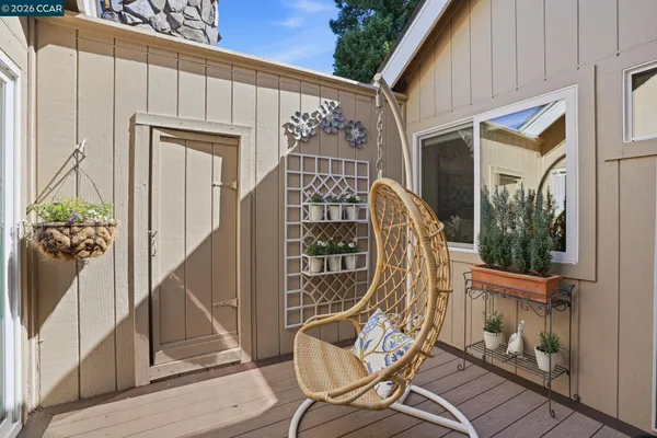 a view of a balcony with chair and the potted plant