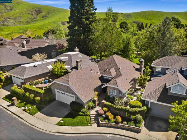an aerial view of a house with garden space and outdoor seating