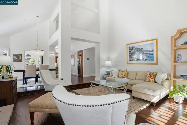 a living room with furniture a rug and a chandelier