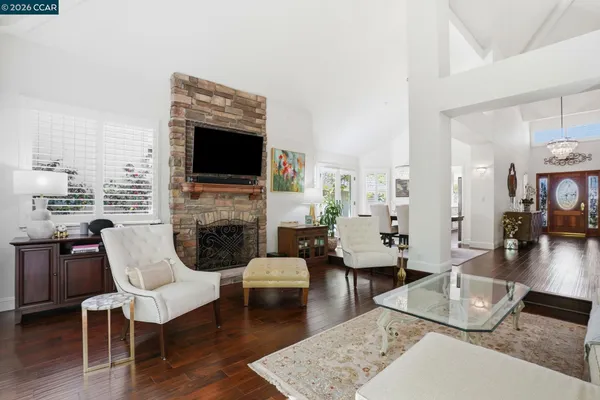 a living room with furniture fireplace and wooden floor