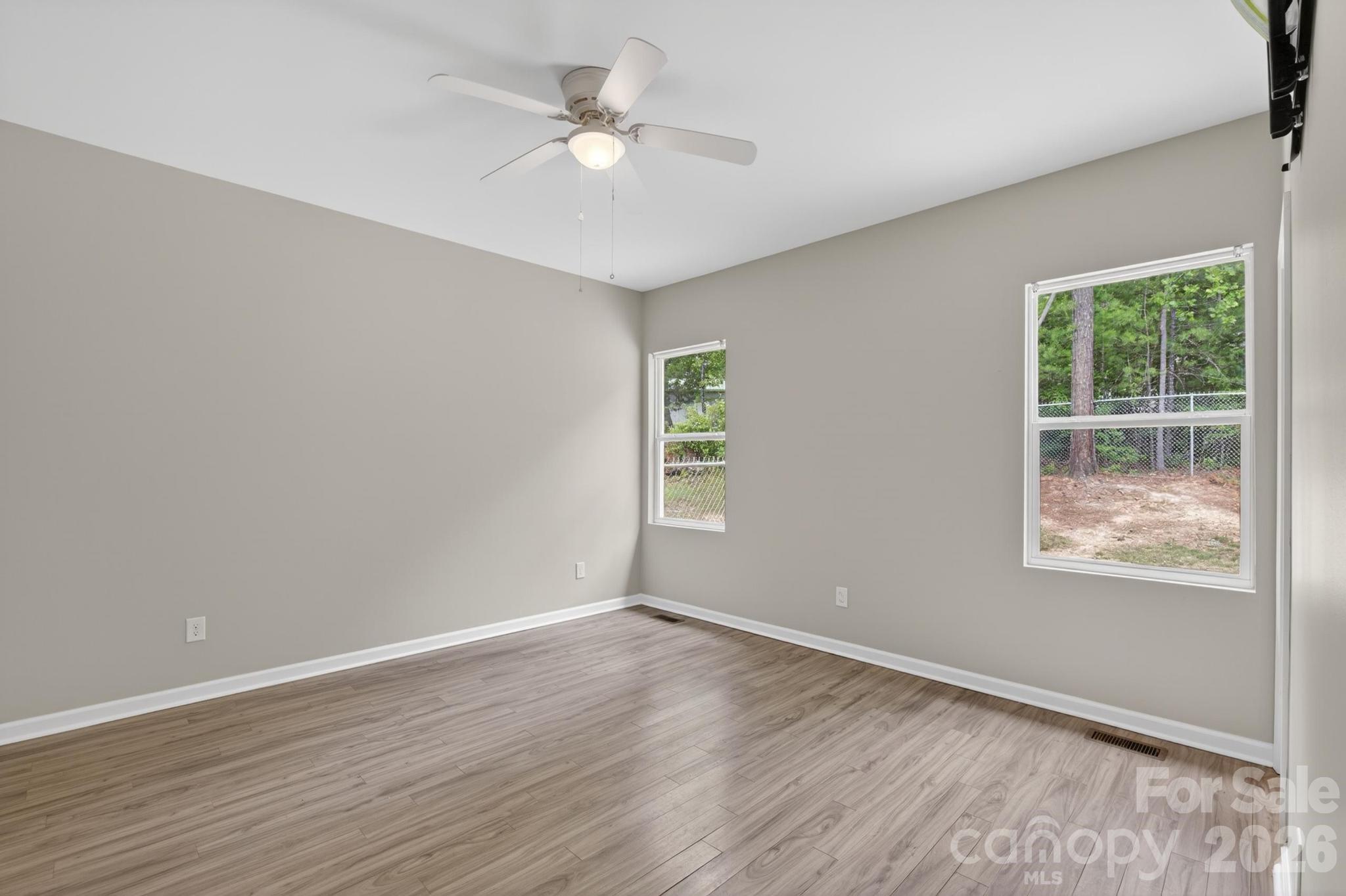 2119 South Road Morganton, NC 28655 - Photo 26 of 47 an empty room with wooden floor and windows