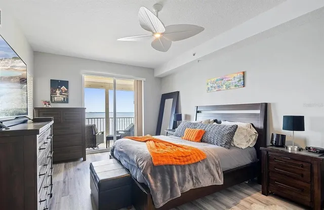 a bedroom with a bed and a large window